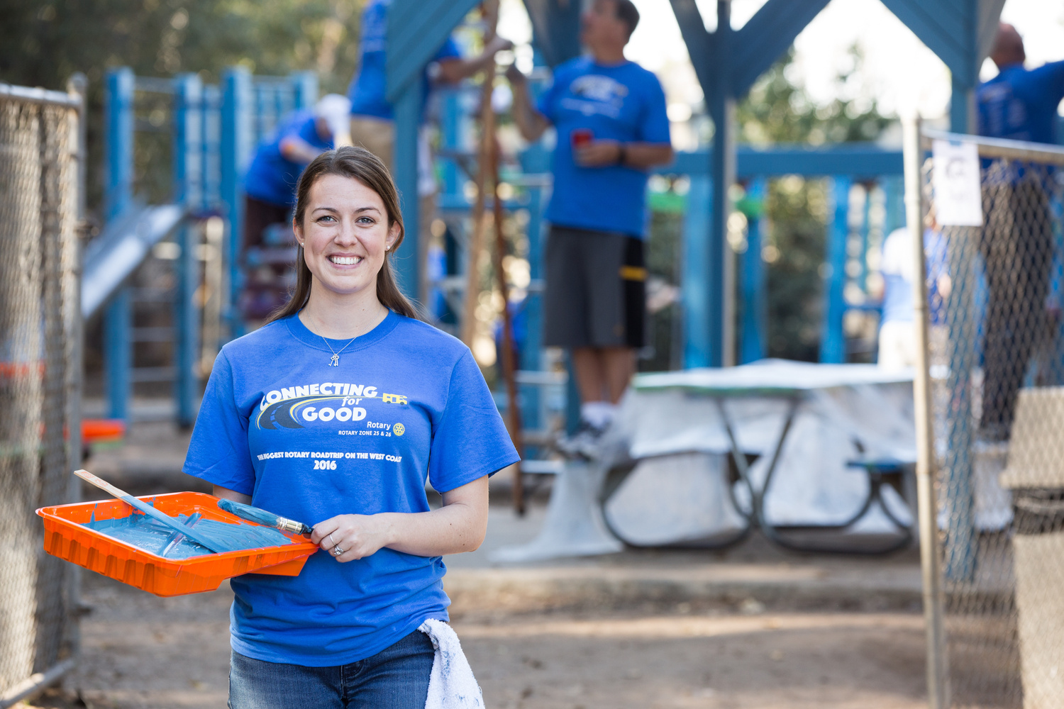 a person in a rotary shirt holding a tray of paint